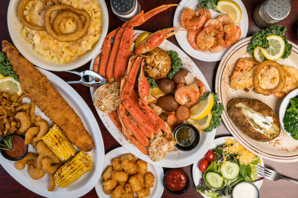 Table top view of breakfast food displayed on table, people eating food.
